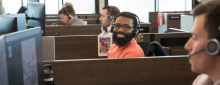 man with headset smiling at camera